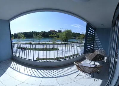 a balcony with a large window with a table and chairs at Apartment Lent in Maribor