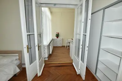a corridor of a room with a bed and a table at Apartment Joja in Ljubljana