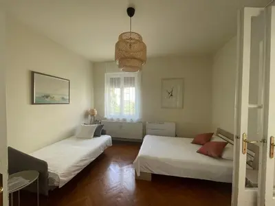 a bedroom with two beds and a window at Apartment Joja in Ljubljana