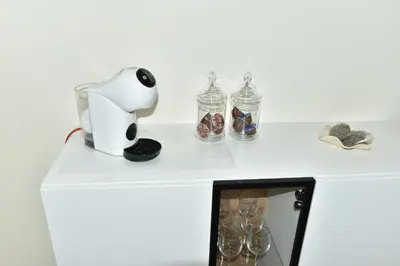 a white table with glass bottles on top of it at Apartment Joja in Ljubljana