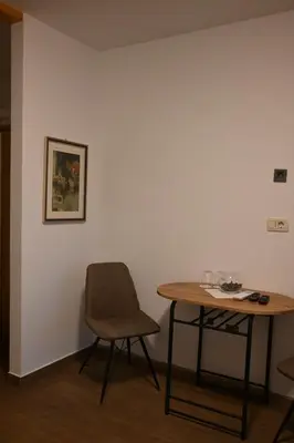 a table and a chair in a room at Hiša Štekar in Kojsko