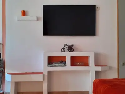 a living room with a tv on a wall at Apartment Norma in Bovec