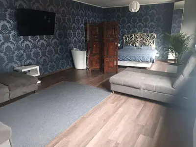 a living room with a bed and a couch at The Cottage in Murska Sobota