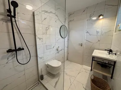a bathroom with a shower and a toilet and a sink at Apartmaji Čepon in Ljubljana