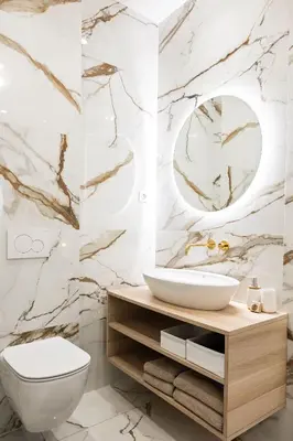 a bathroom with a white toilet and a sink at MARIANNA'S OLD TOWN RESIDENCE in Ljubljana