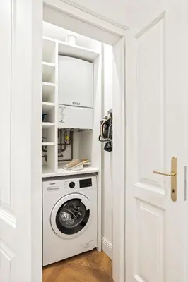 a white laundry room with a washer and dryer at MARIANNA'S OLD TOWN RESIDENCE in Ljubljana