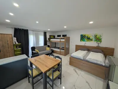 a living room with a bed and a table at TOMO 2 in Postojna