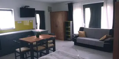 a living room with a couch and a table at TOMO 2 in Postojna