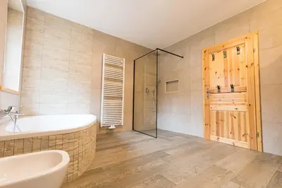 a bathroom with a tub and a sink and a shower at LARCH HOUSE in Cerklje na Gorenjskem