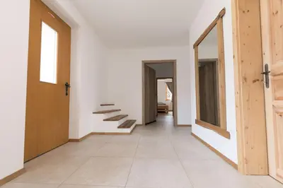 an empty hallway with stairs on the wall at LARCH HOUSE in Cerklje na Gorenjskem