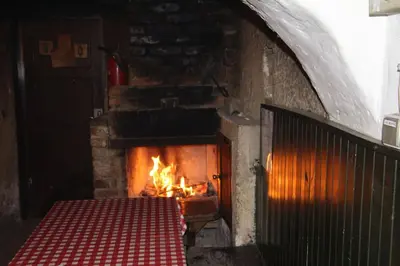 a brick oven with a fire in it at Home Puščava in Kranj
