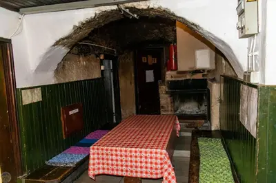 a room with a table in a room with an oven at Home Puščava in Kranj