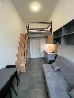 a living room with a couch and a loft at Studio Spark Ljubljana in Ljubljana