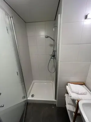 a bathroom with a shower and a sink at Studio Spark Ljubljana in Ljubljana