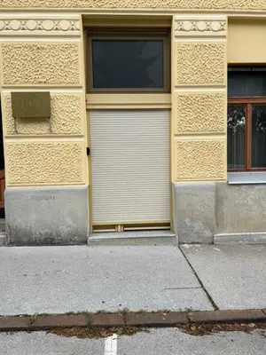 a building with two garage doors on the side of it at Studio Spark Ljubljana in Ljubljana