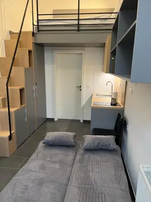 a room with a loft with two pillows on the floor at Studio Spark Ljubljana in Ljubljana