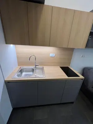 a kitchen with a sink and a wooden counter top at Studio Spark Ljubljana in Ljubljana