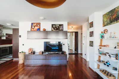a living room with a television on a wooden floor at Cozy Nest in quiet neighbourhood, free parking in Ljubljana