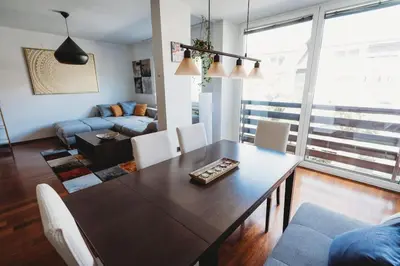 a living room with a table and a couch at Cozy Nest in quiet neighbourhood, free parking in Ljubljana
