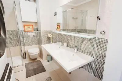 a bathroom with a sink and a toilet at Cozy Nest in quiet neighbourhood, free parking in Ljubljana