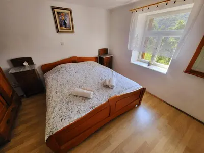 a bedroom with a bed with two towels on it at Čukova bajta in Most na Soči
