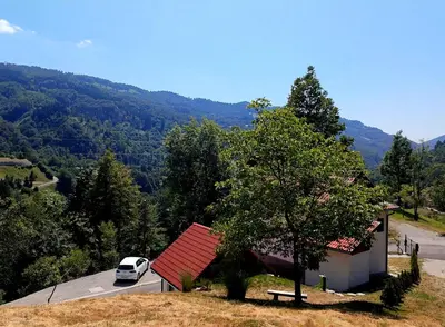 a car parked next to a house with a red roof at Čukova bajta in Most na Soči