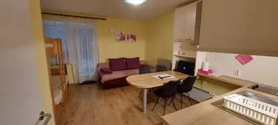 a small living room with a table and a couch at Apartma Rogla Gaber 110 in Zreče