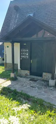 a building with a door with a sign on it at Apartma Rogla Gaber 110 in Zreče
