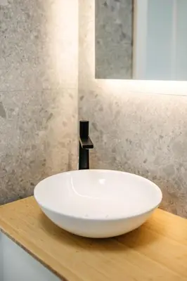 a white sink on a wooden counter in a bathroom at Cozy A-Frame Retreat Near Ljubljana With Hot Tub in Cerklje na Gorenjskem