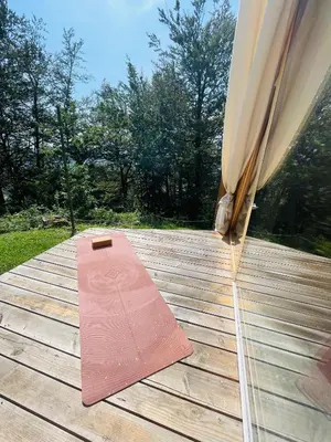 a wooden deck with a yoga mat on it at Cozy A-Frame Retreat Near Ljubljana With Hot Tub in Cerklje na Gorenjskem