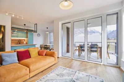a living room with a couch and a table at Apartments Svitnjak in Bovec