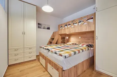 a bedroom with a large wooden bunk bed at Apartments Svitnjak in Bovec