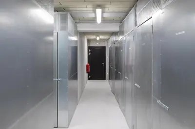 a hallway with glass walls and a black door at Apartments Svitnjak in Bovec