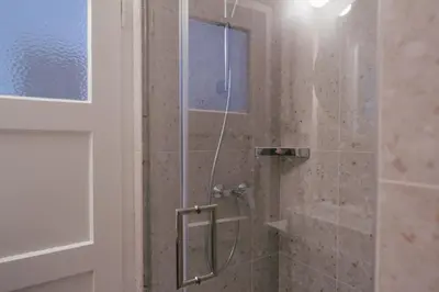 a shower with a glass door in a bathroom at Luxury 2 bedroom NEW apartment with private parking in Ljubljana