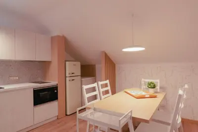 a kitchen with a table and chairs in a room at Luxury 2 bedroom NEW apartment with private parking in Ljubljana
