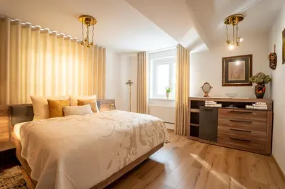 a bedroom with a bed and a dresser and a window at Residence Moritz with Sauna in Mozirje