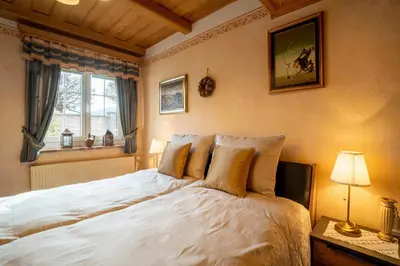 a bedroom with a large white bed with a window at Residence Moritz with Sauna in Mozirje