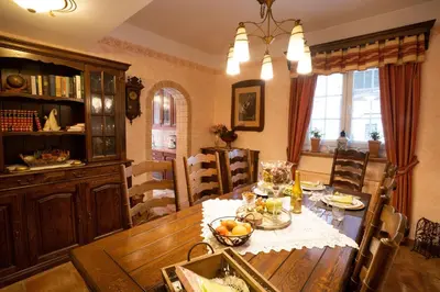 a dining room with a wooden table and chairs at Residence Moritz with Sauna in Mozirje
