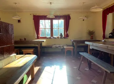 a restaurant with wooden tables and benches in a room at Traditional Slovenian house in Vransko