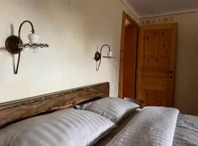 a bed with a wooden headboard in a bedroom at Traditional Slovenian house in Vransko