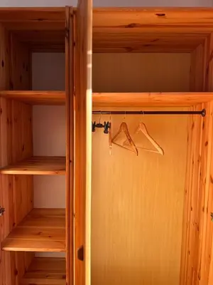 a closet with wooden shelves and a pair of hangers at Vanessa Apartment in Ljubljana