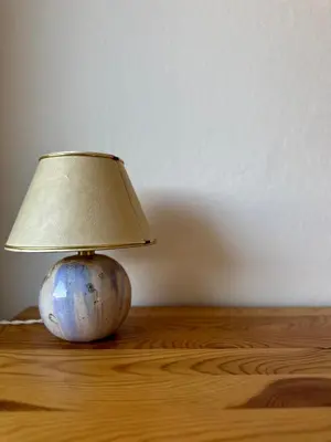 a lamp sitting on top of a wooden table at Vanessa Apartment in Ljubljana