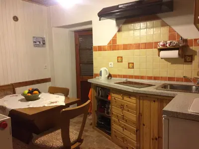 a kitchen with a sink and a table with a tableablish at Apartments Torkar in Bled