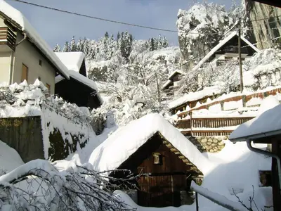 a snow covered roof of a house with snow at Apartments Torkar in Bled