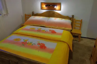 a bedroom with a bed with a colorful bedspread at Apartments Torkar in Bled
