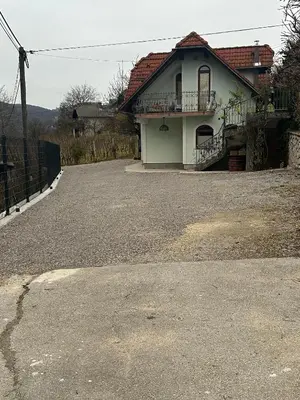 a house sitting on top of a gravel driveway at ZIDANICA MEDLE in Otočec