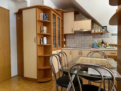 a kitchen with a table and chairs in a room at ZIDANICA MEDLE in Otočec