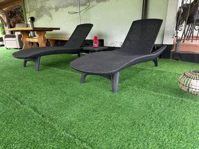 two black chairs sitting on a green carpet at ZIDANICA MEDLE in Otočec