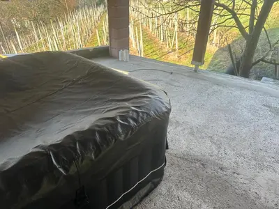a bed sitting on top of a patio at ZIDANICA MEDLE in Otočec