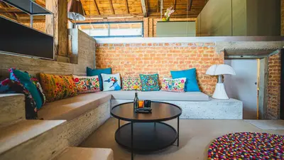 a living room with a couch and a table at Premium Gardenguesthouse Mlinar with Pool & Sauna in Fokovci